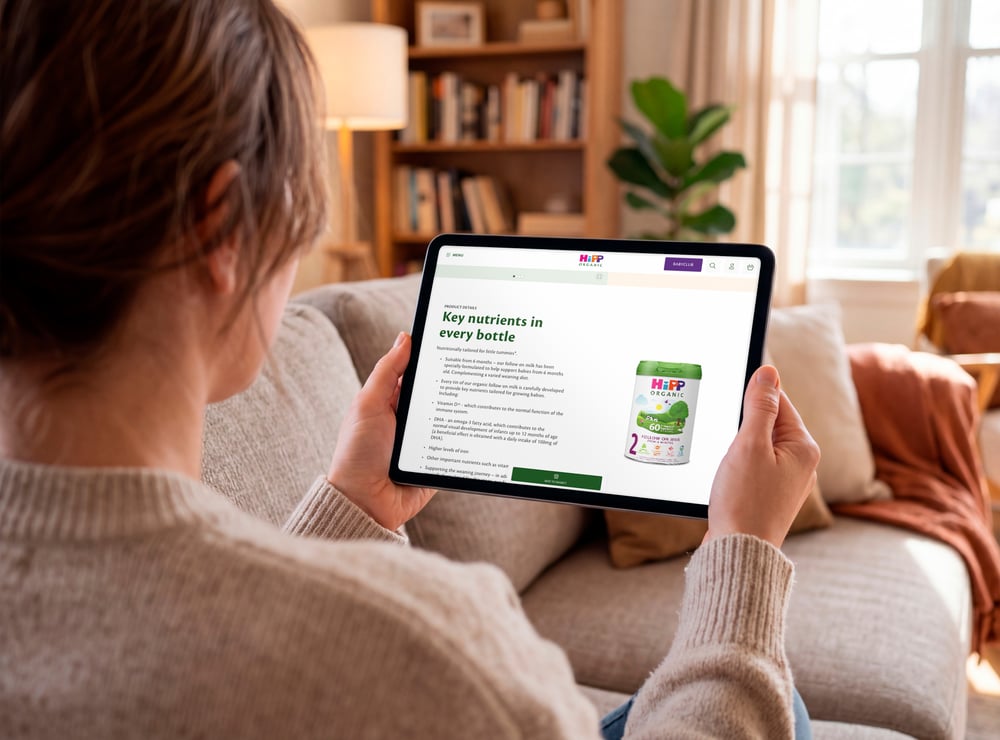 Women holding an ipad looking at HiPP baby formula on the website