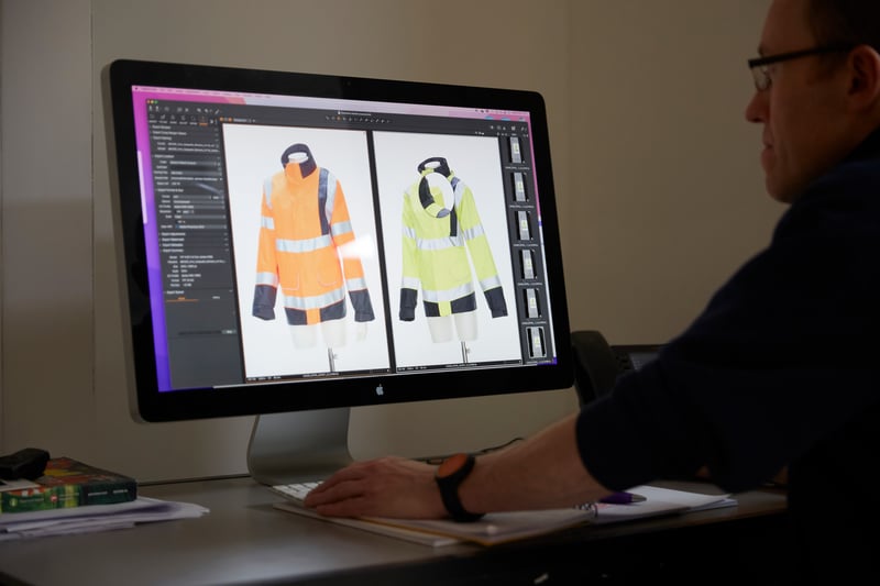 WK360 employee retouching a high-vis jacket on a computer