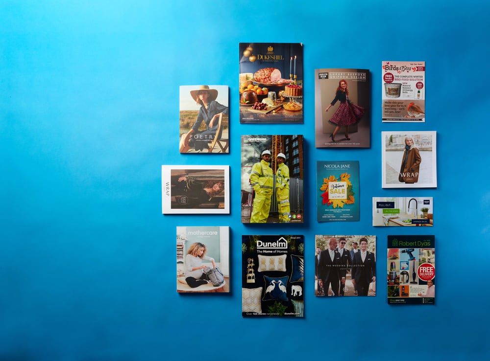 A selection of consumer brand brochure designs on a blue background.