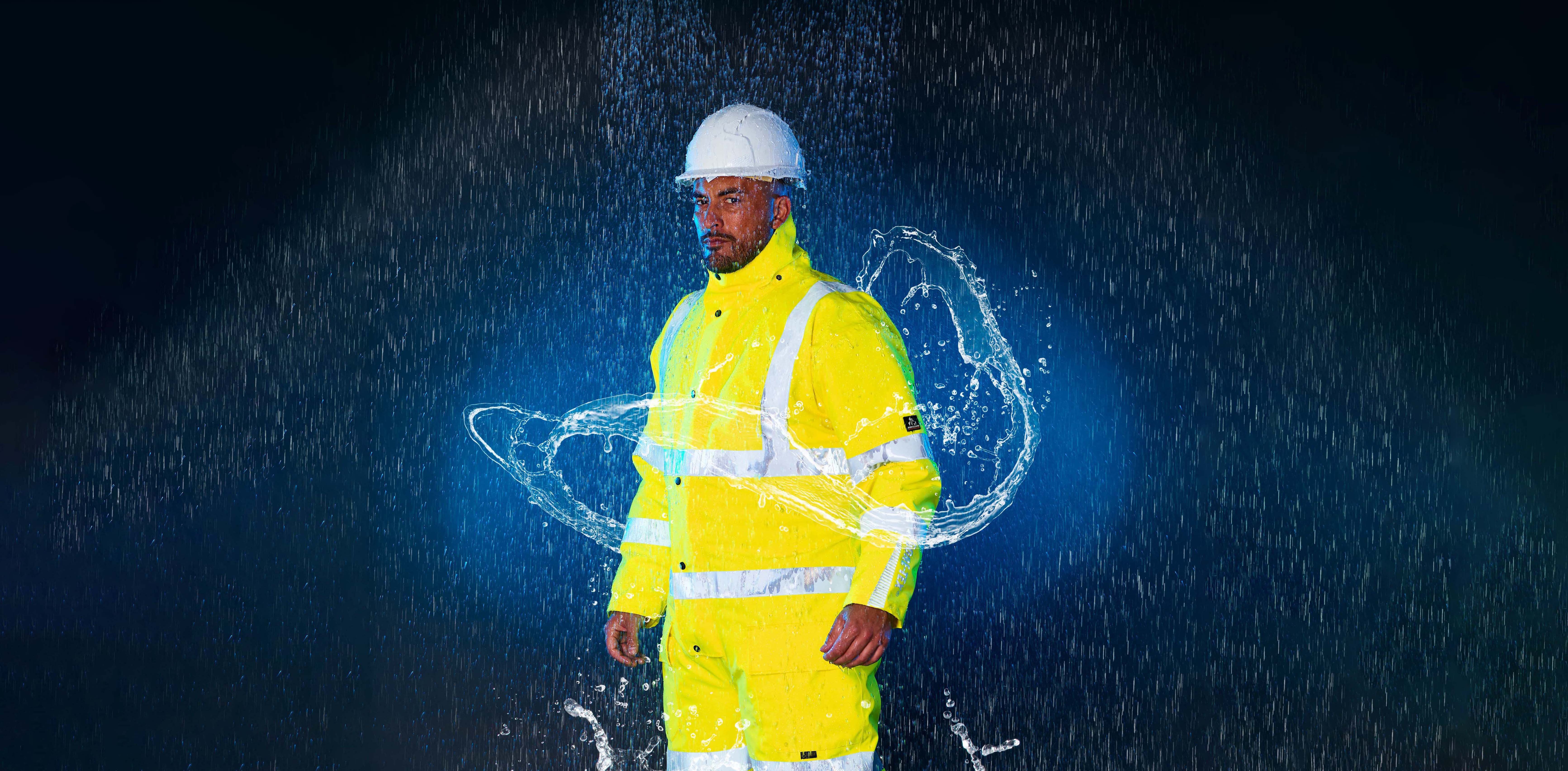 Worker in high vis with rain falling and water swirling. CGI and photography shot.
