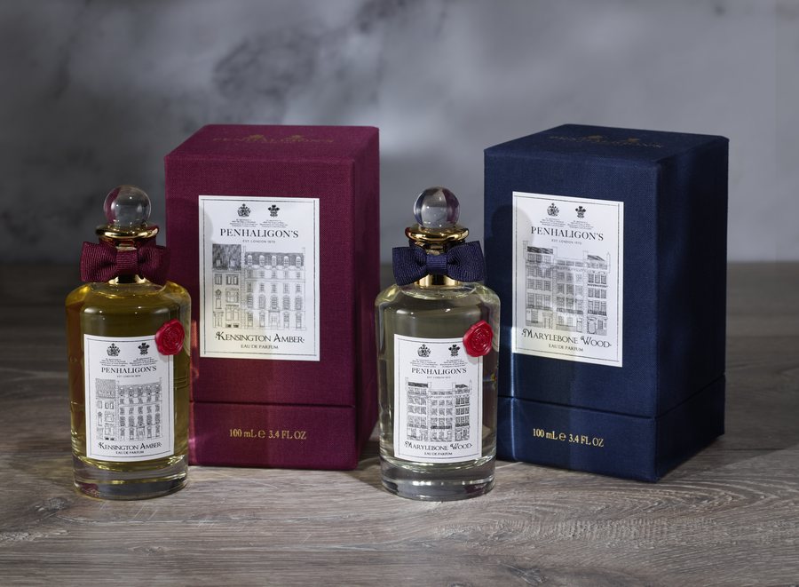 Optimised product image of two luxury fragrance bottles with their gift boxes against a stone backdrop
